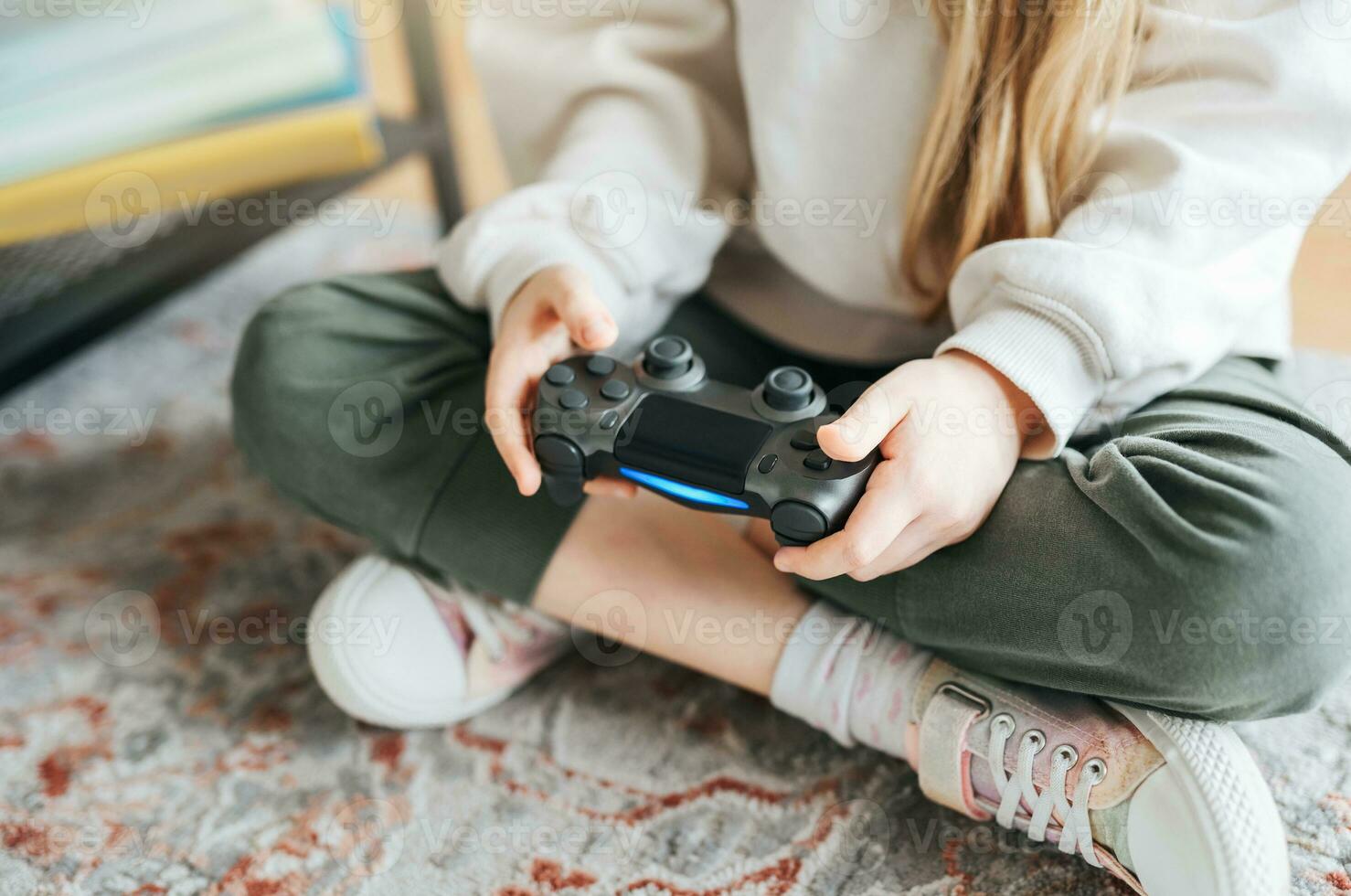 Girl playing video game at home photo