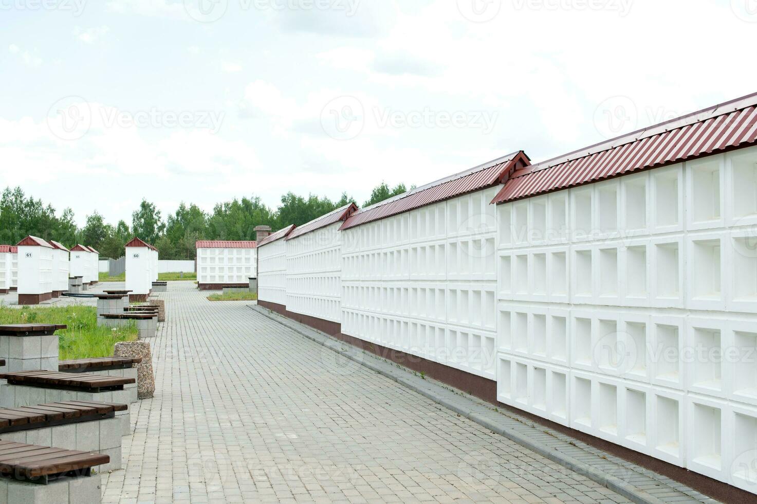A wall with new empty niches for cremation. A row of empty graves for funeral urns. photo