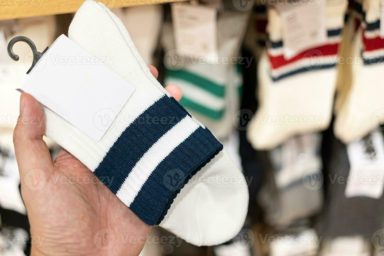 socks with blank tag. man choosing socks at the shop photo
