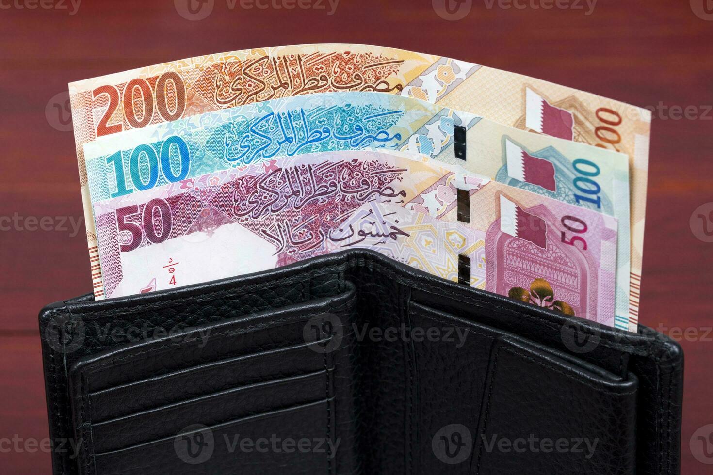 Qatari money in the black wallet photo