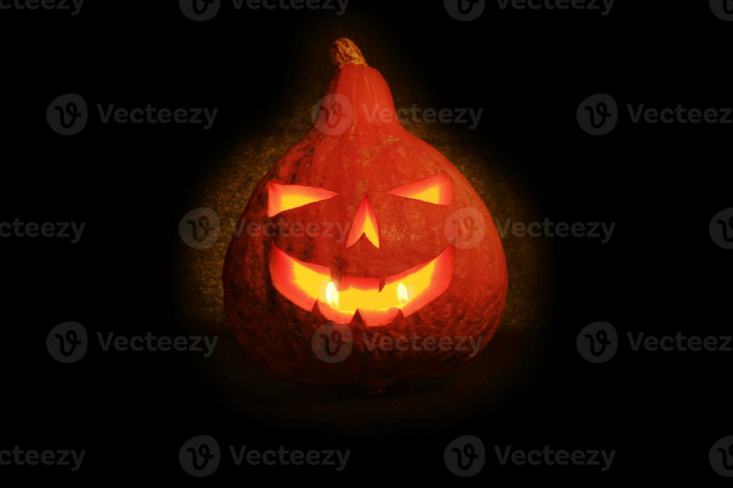 Jack O' Lantern lit in the dark photo