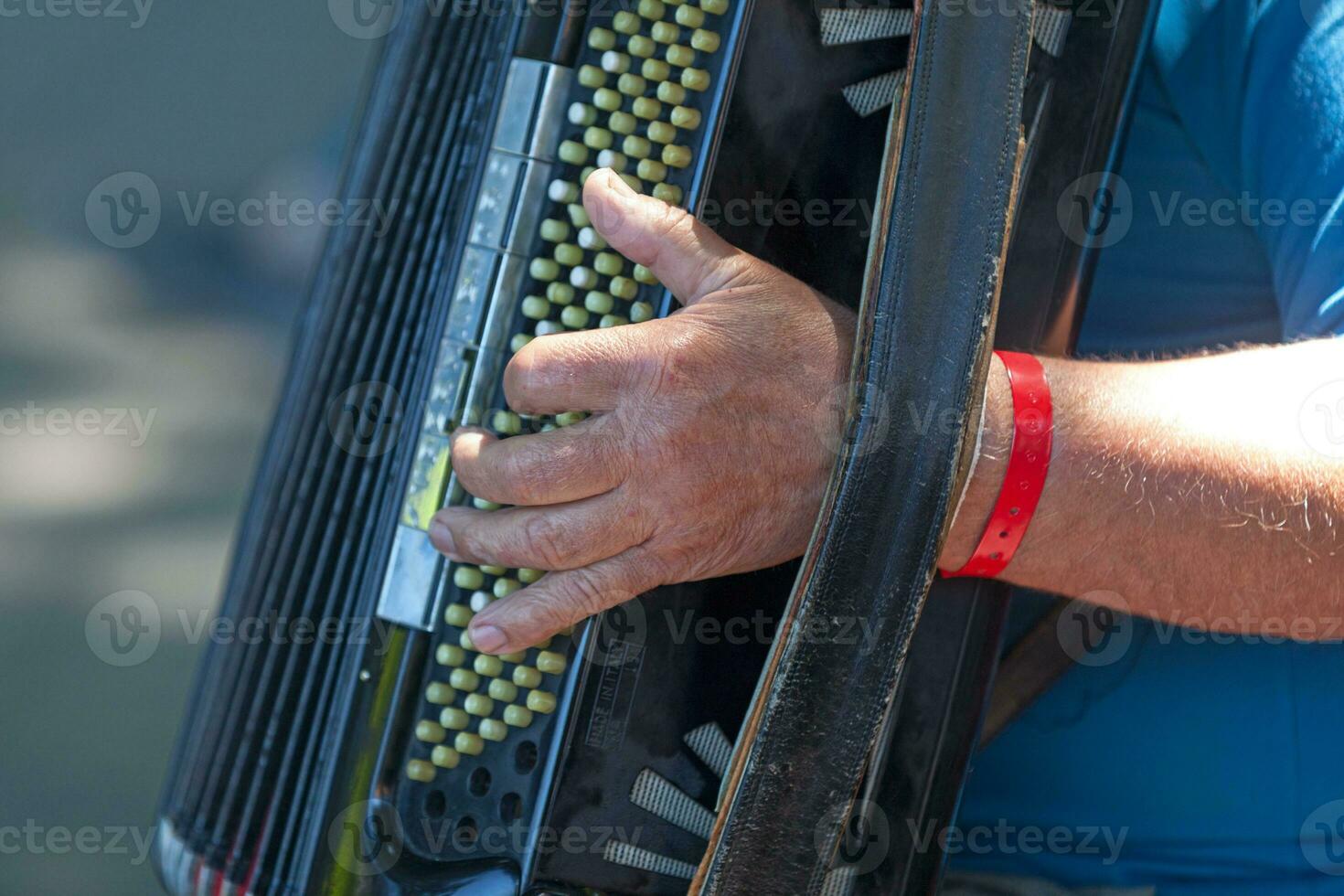 Musician playing with an accordion photo