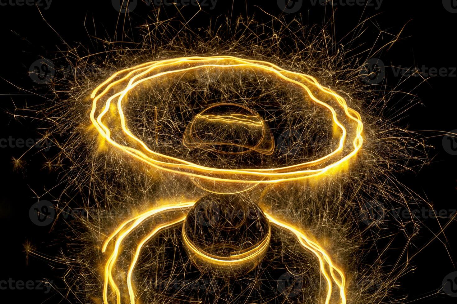 Abstract light painting with a sparkler circling around a glass ball photo