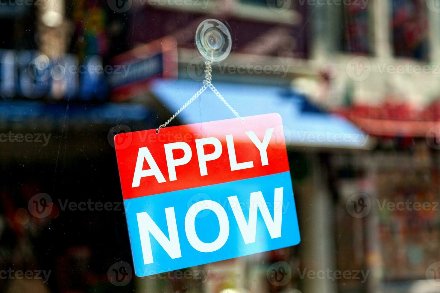 Apply now sign in a store window photo