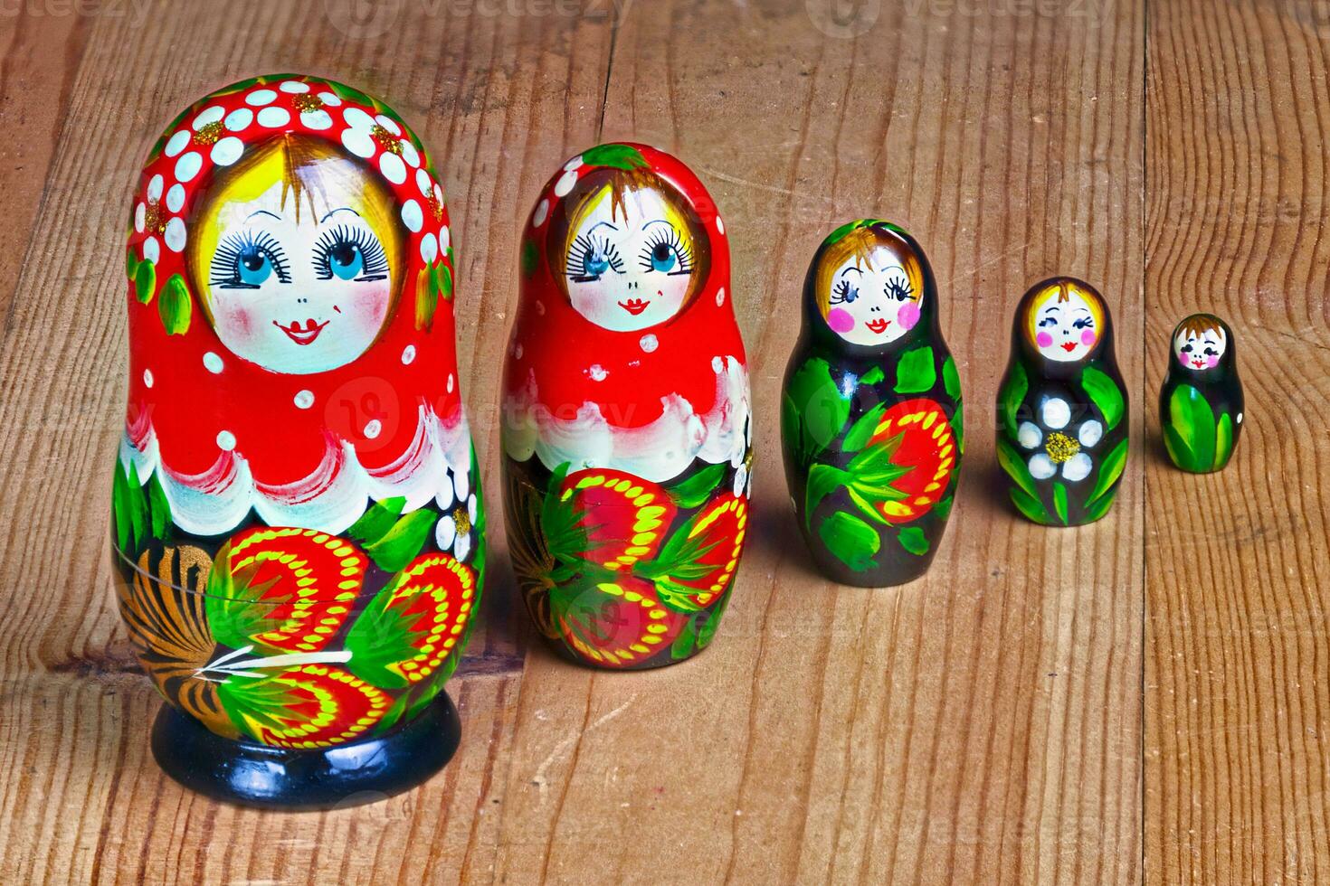 Matryoshka dolls set on a wooden table photo