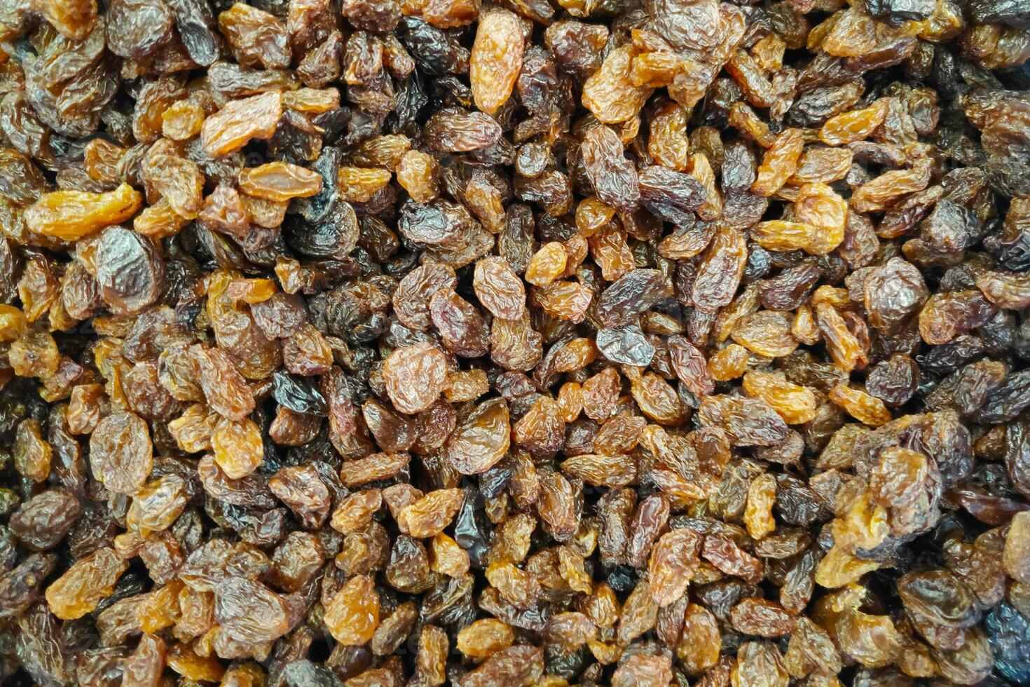 Stack of organic dried black raisins on a market stall photo