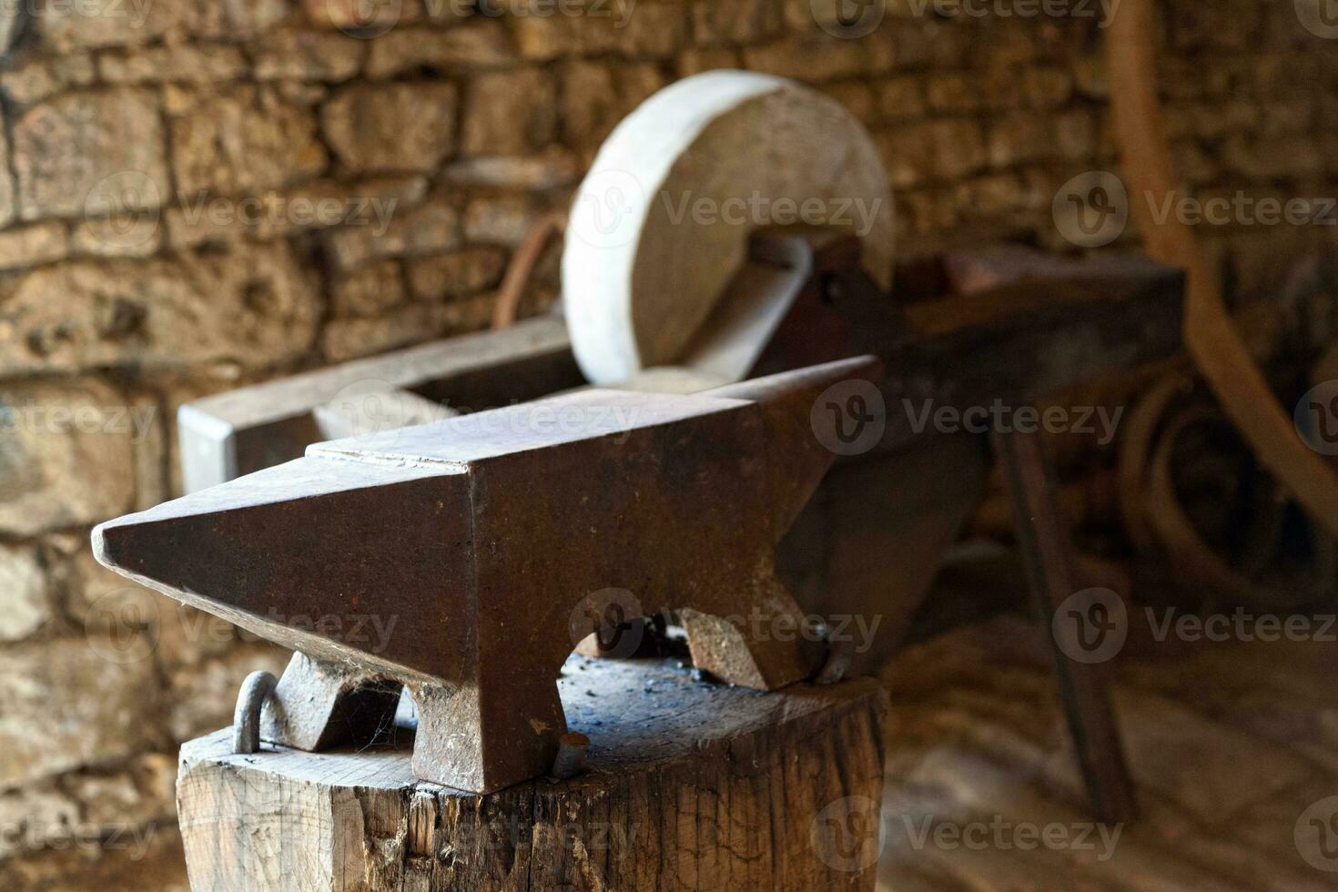 Anvil and a grinding wheel photo