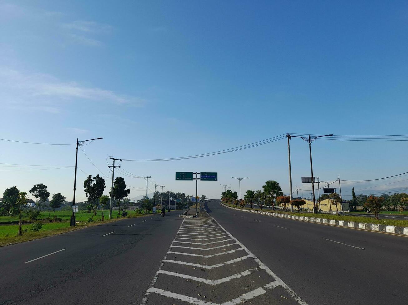 Lombok Island, Indonesia.20 May 2023. Slow and fast lane dividing sign on road in Lombok island, Indonesia photo