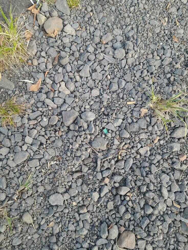 Small stones arranged irregularly in the road side photo