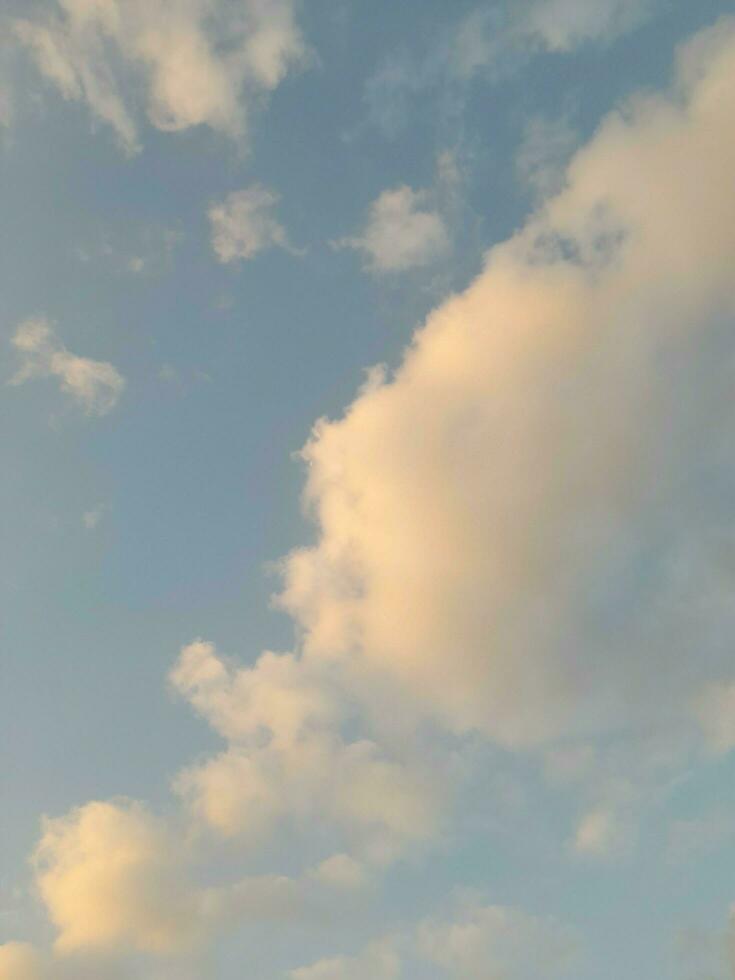 Beautiful white clouds on deep blue sky background. Large bright soft fluffy clouds are cover the entire blue sky. photo