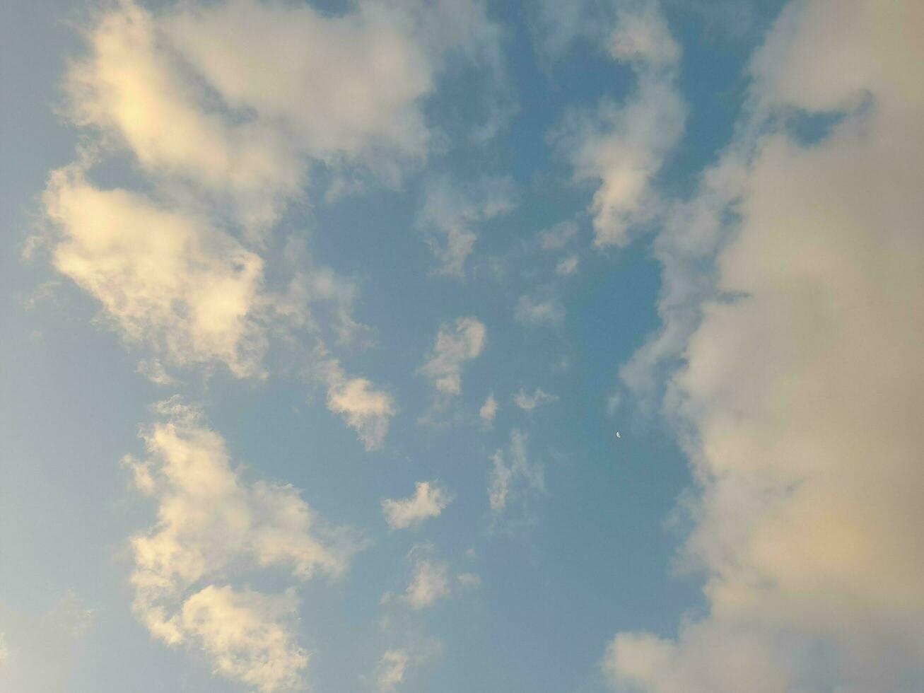 Beautiful white clouds on deep blue sky background. Large bright soft fluffy clouds are cover the entire blue sky. photo