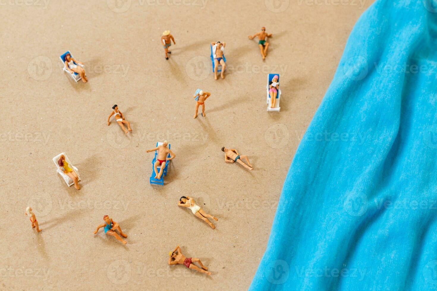 A tiny person in a swimsuit is relaxing on the beach in the summer photo
