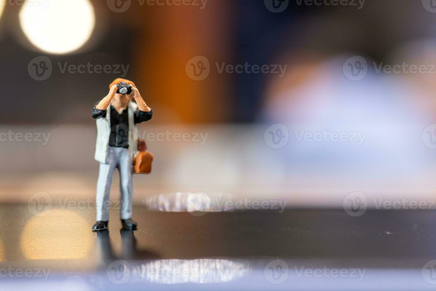 Miniature people Photography holding a camera and copy space for text photo