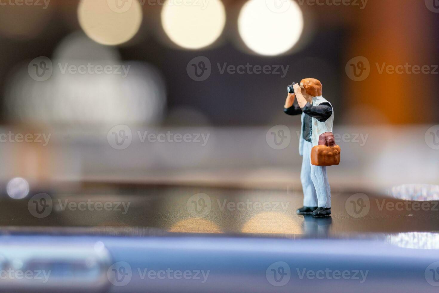 Miniature people Photography holding a camera and copy space for text photo