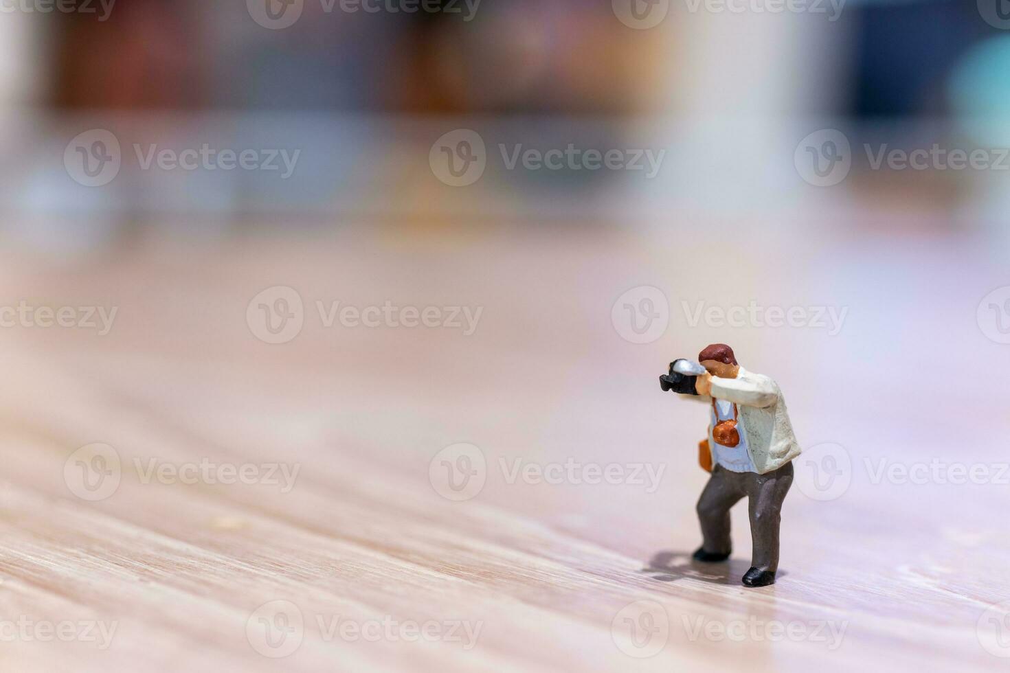 Miniature people Photography holding a camera and copy space for text photo
