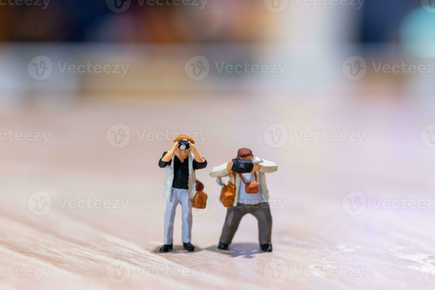 Miniature people Photography holding a camera and copy space for text photo