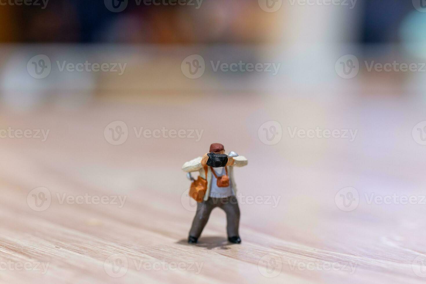 Miniature people Photography holding a camera and copy space for text photo