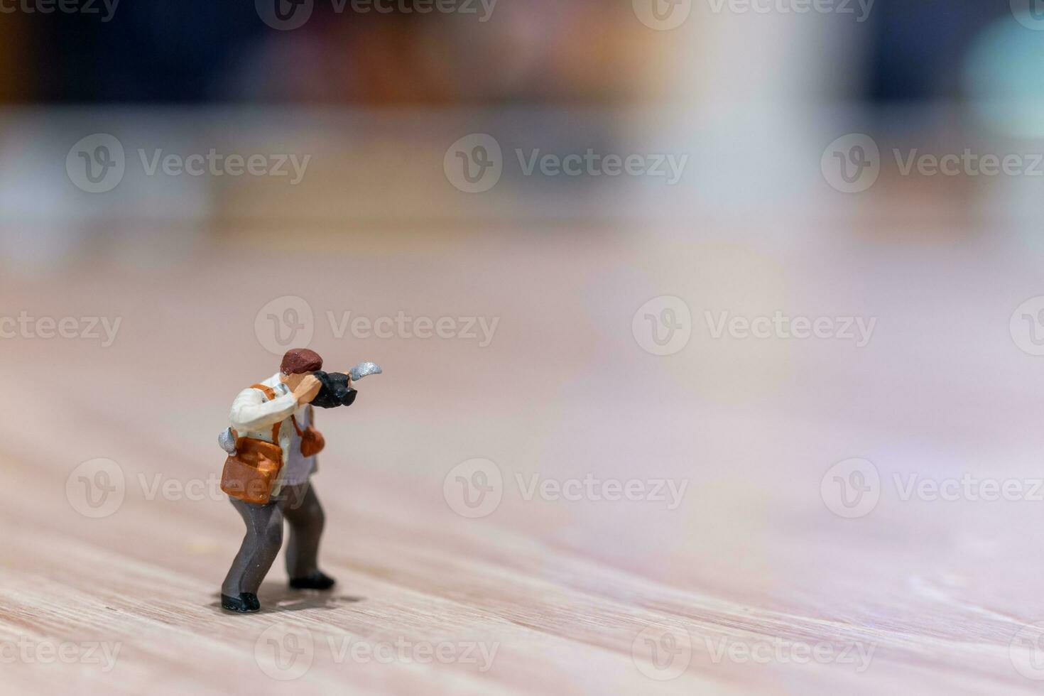 Miniature people Photography holding a camera and copy space for text photo