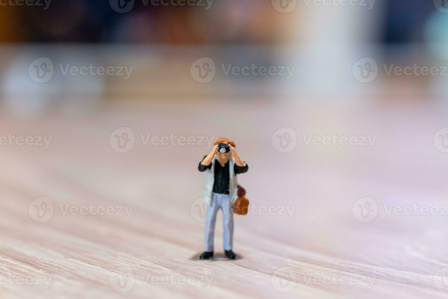 Miniature people Photography holding a camera and copy space for text photo