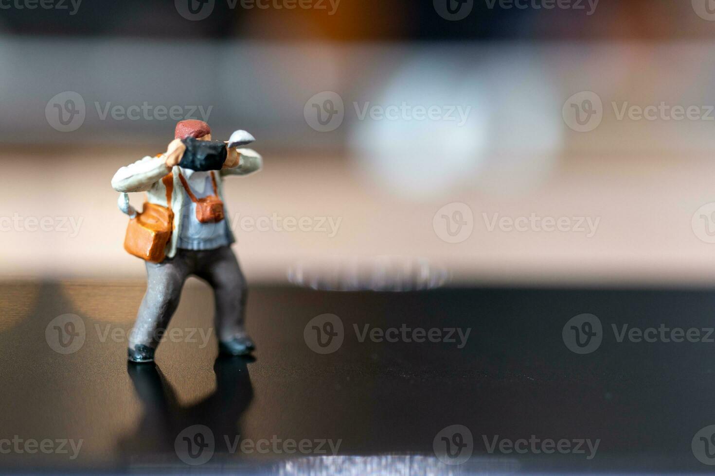 Miniature people Photography holding a camera and copy space for text photo