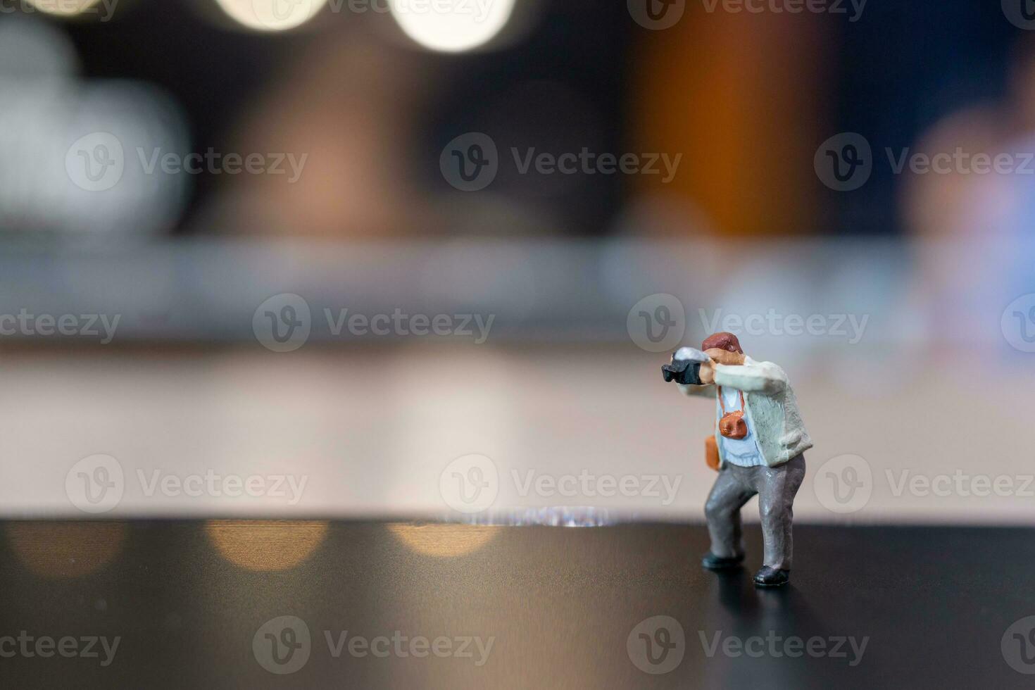 Miniature people Photography holding a camera and copy space for text photo