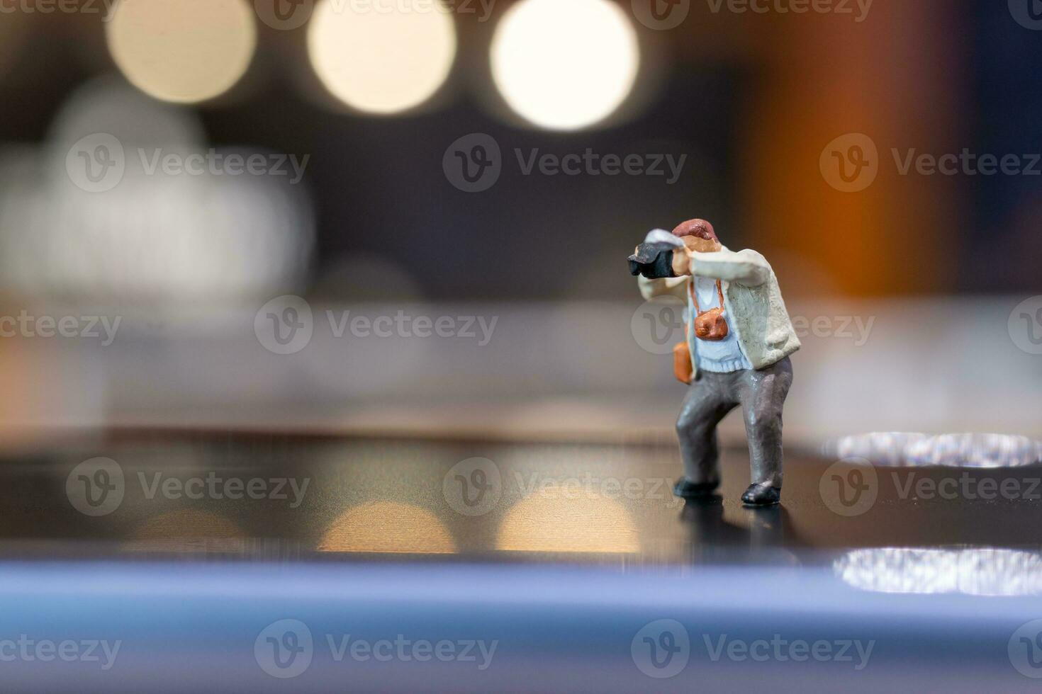 Miniature people Photography holding a camera and copy space for text photo