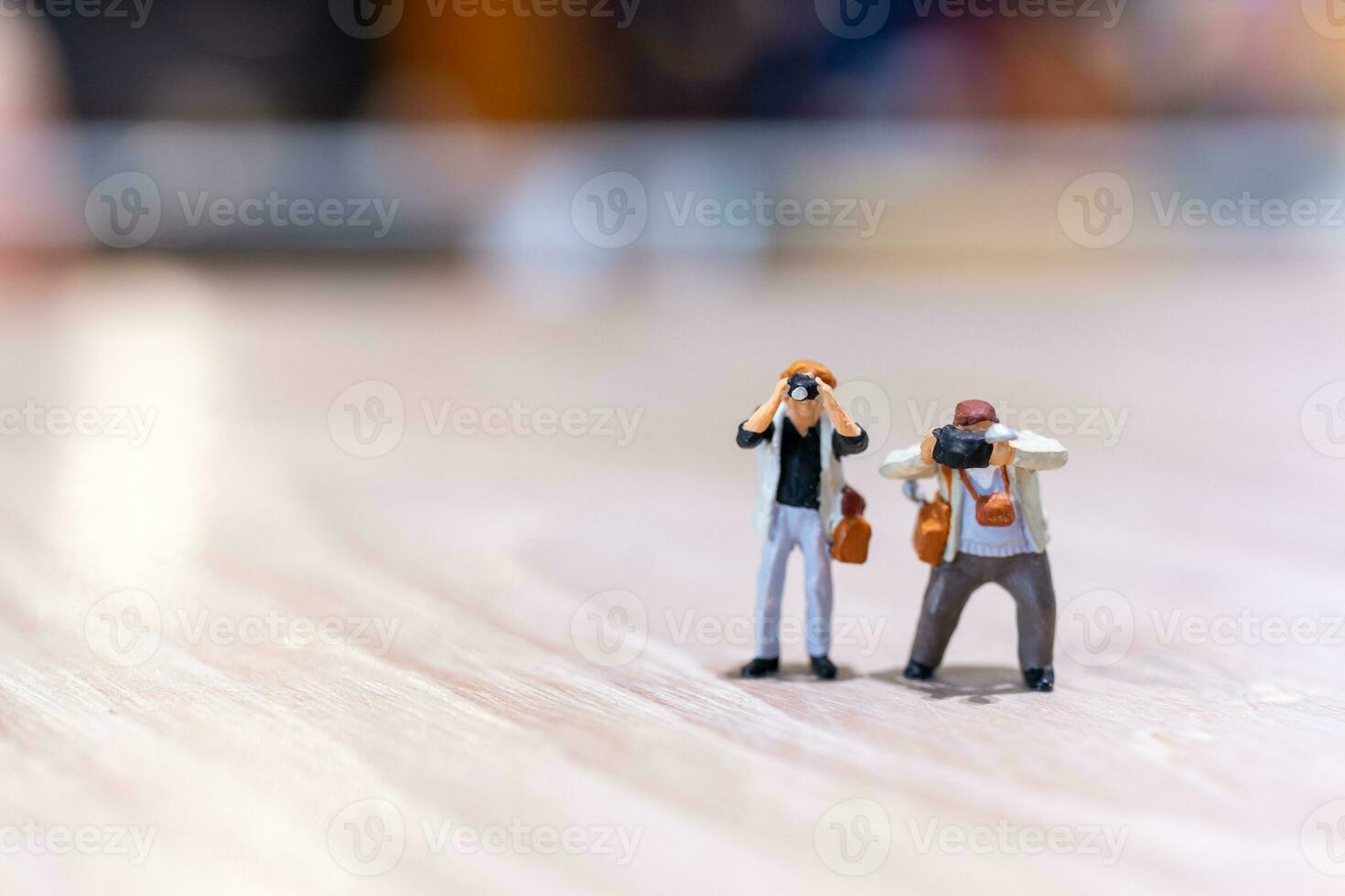 Miniature people Photography holding a camera and copy space for text photo