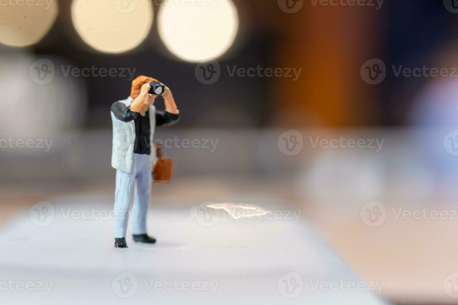 Miniature people Photography holding a camera and copy space for text photo