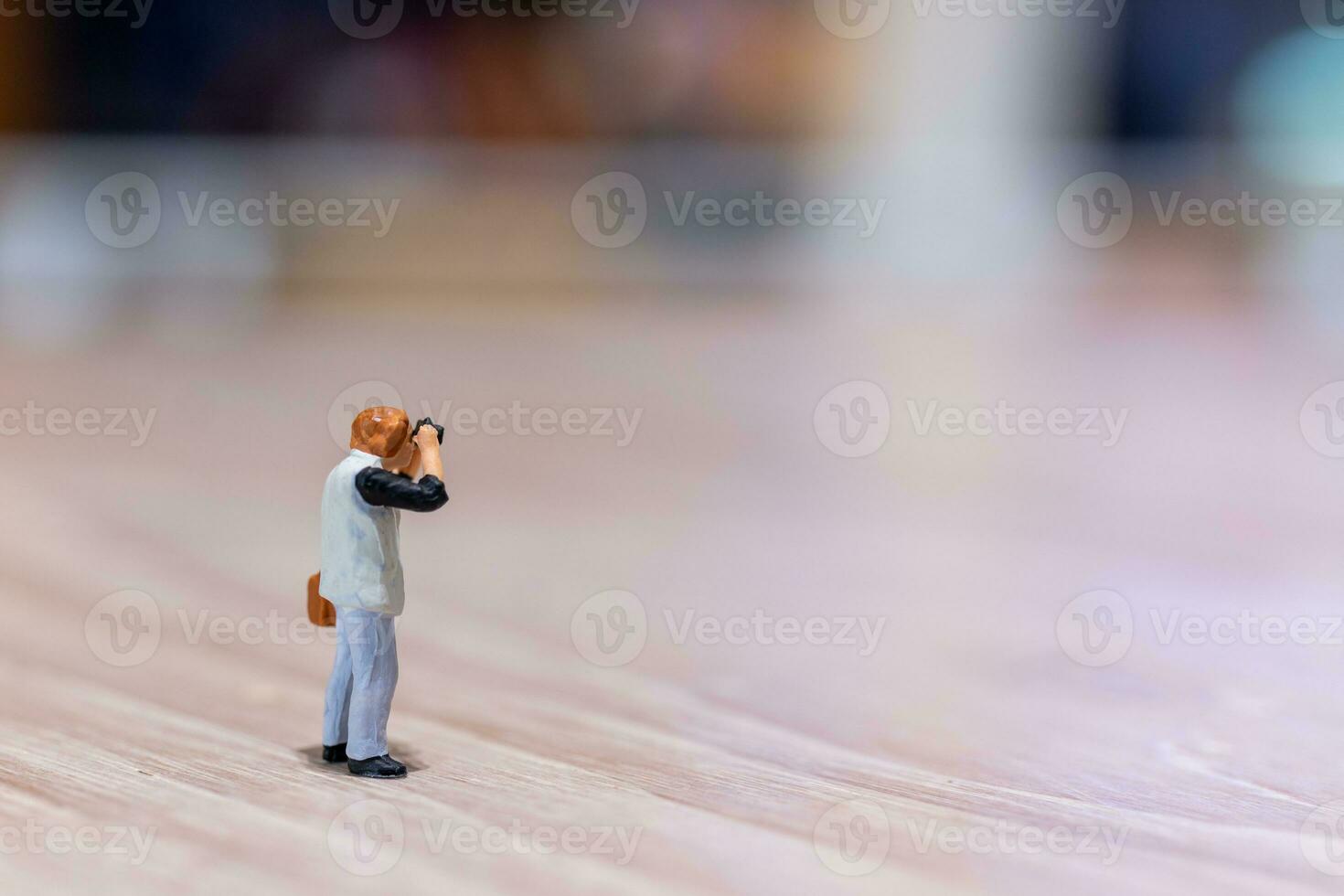 Miniature people Photography holding a camera and copy space for text photo