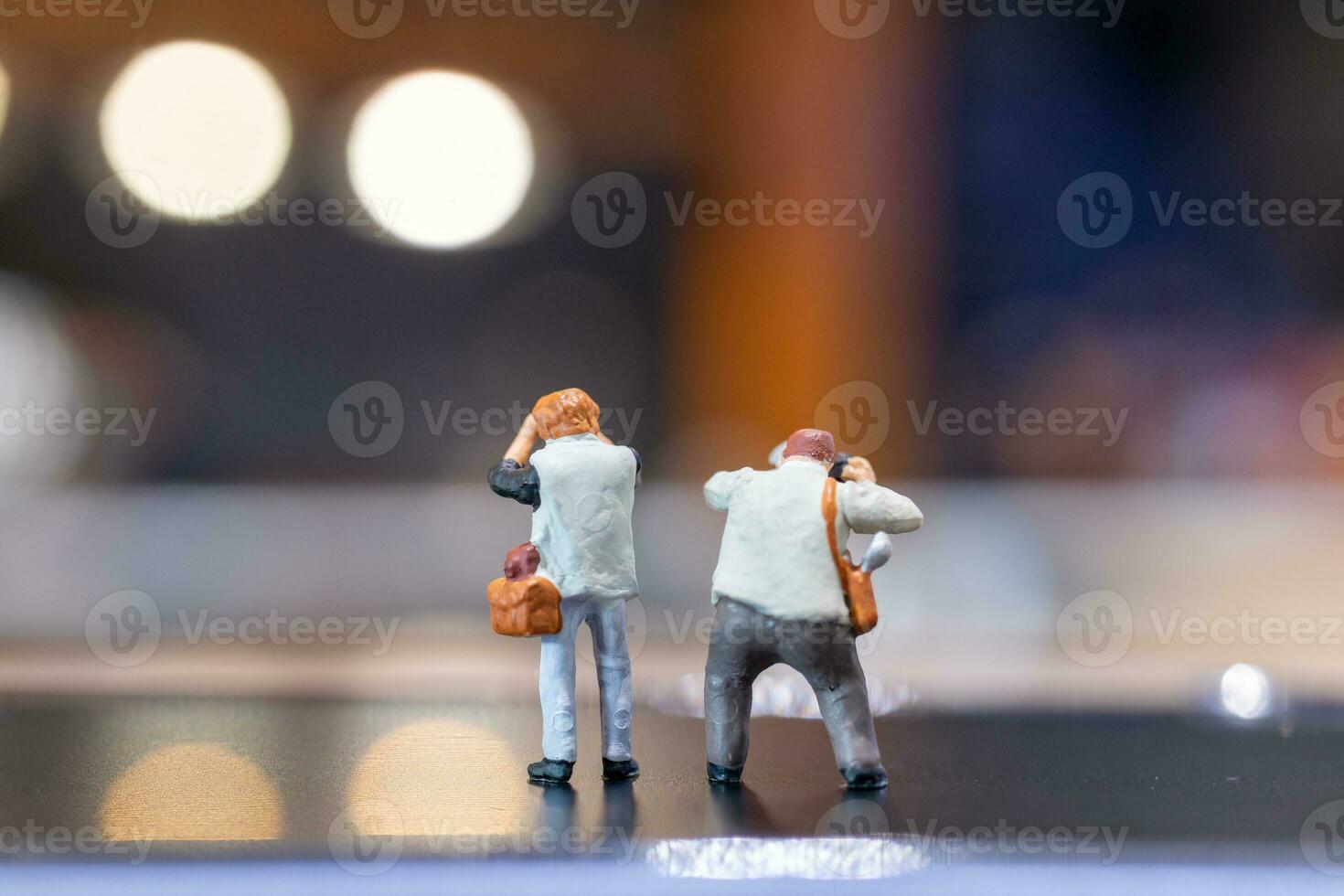Miniature people Photography holding a camera and copy space for text photo