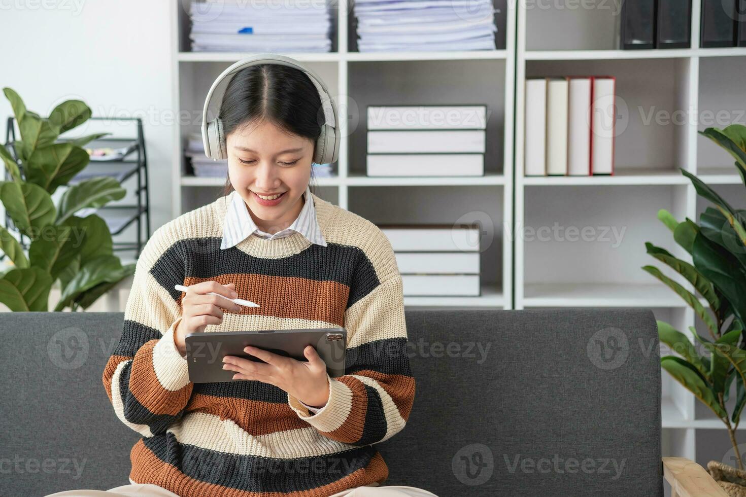 Asian girl students study online, stay at home, teacher, video call, and zoom online. Happy Asian girl learning English online with laptop computer, tablet and mobile phone. online learning concept. photo