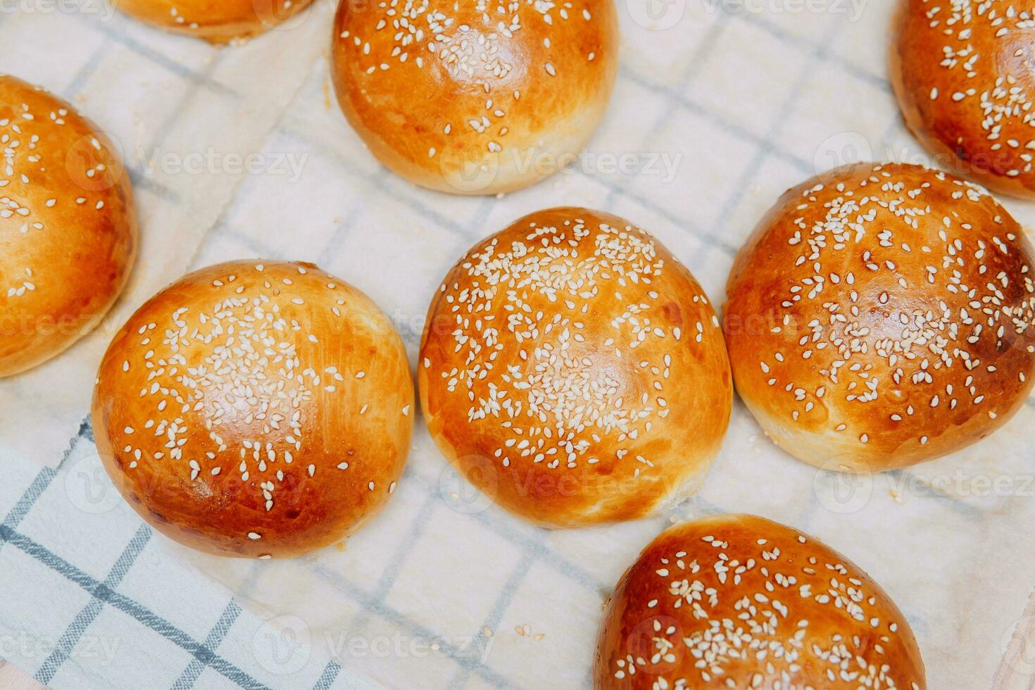 Freshly baked burger buns with sesame seeds. We cook at home. photo