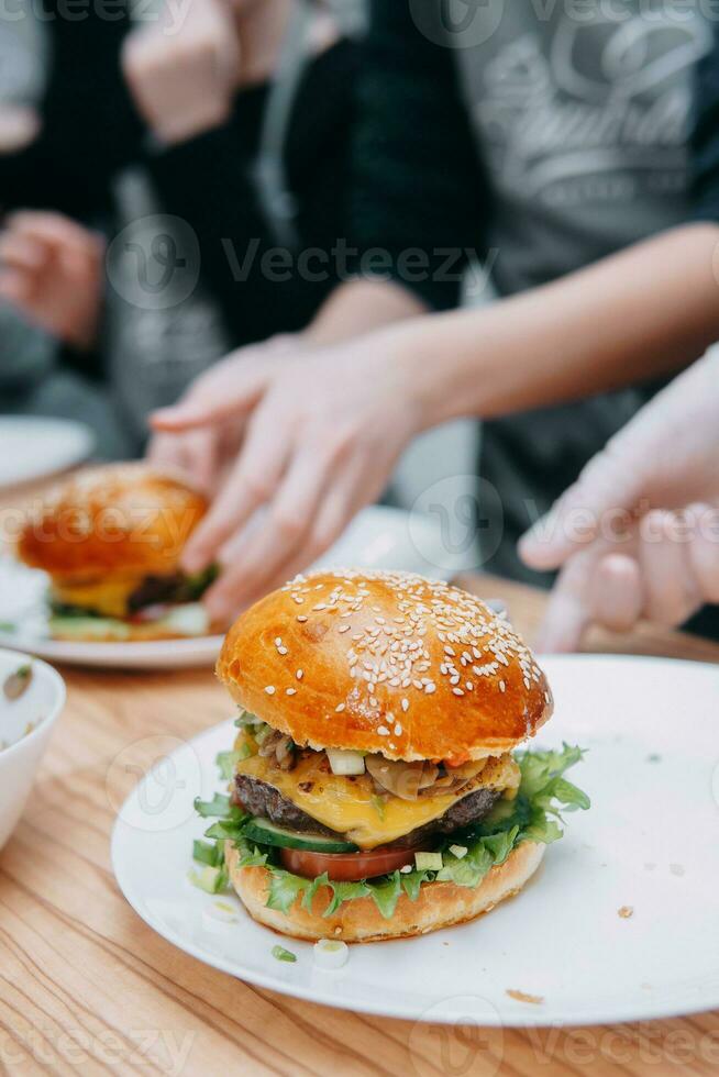 Burgers with beef and vegetables. Close up. Delicious burgers in a cooking class. Burger with cranberry sauce and Burger with onion sauce. photo