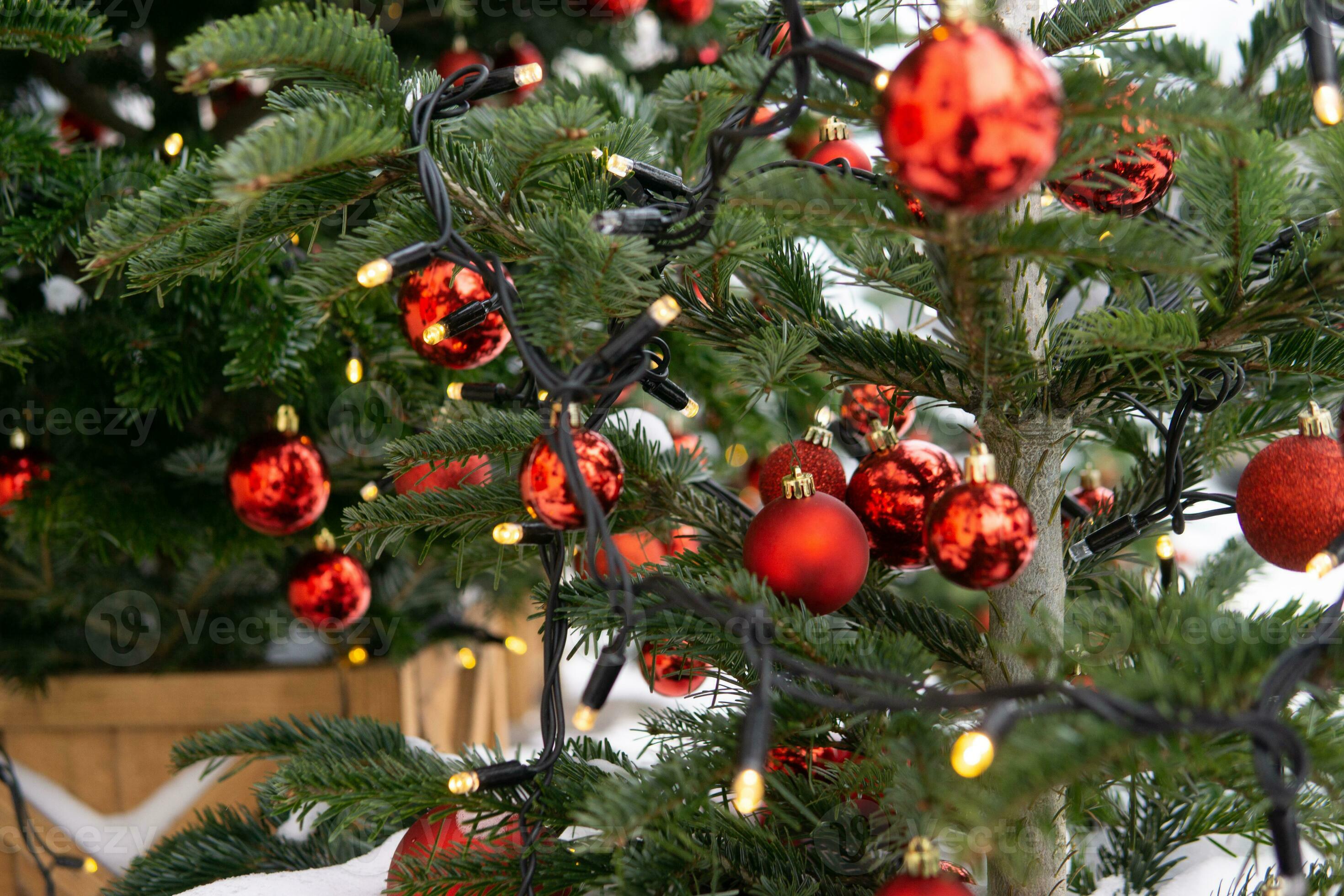 Christmas trees decorated with red balloons in front of the entrance to