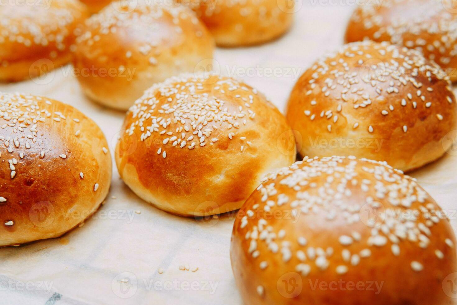 Freshly baked burger buns with sesame seeds. We cook at home. photo