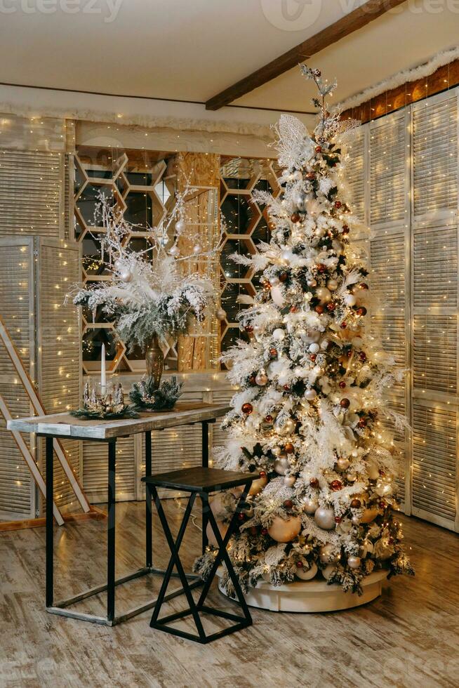 Home Christmas interior, with a Christmas tree and lots of glowing garlands and light bulbs. Preparing for the Christmas party at home. photo