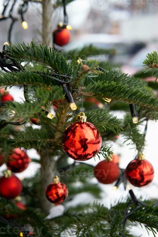 Christmas trees decorated with red balloons in front of the cafe entrance. Street Christmas decorations. photo