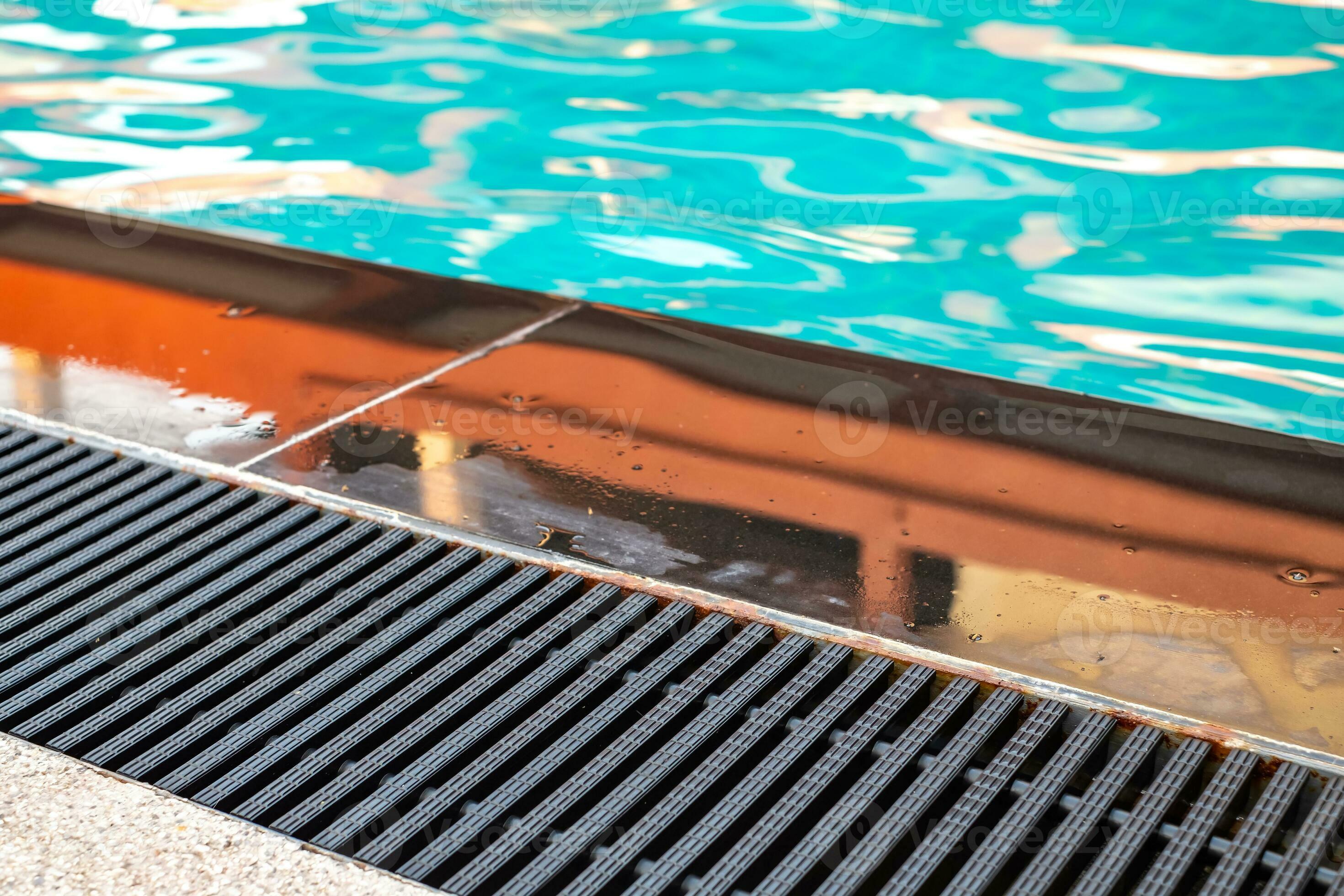 Black gutter is installed beside swimming pool, drainage system