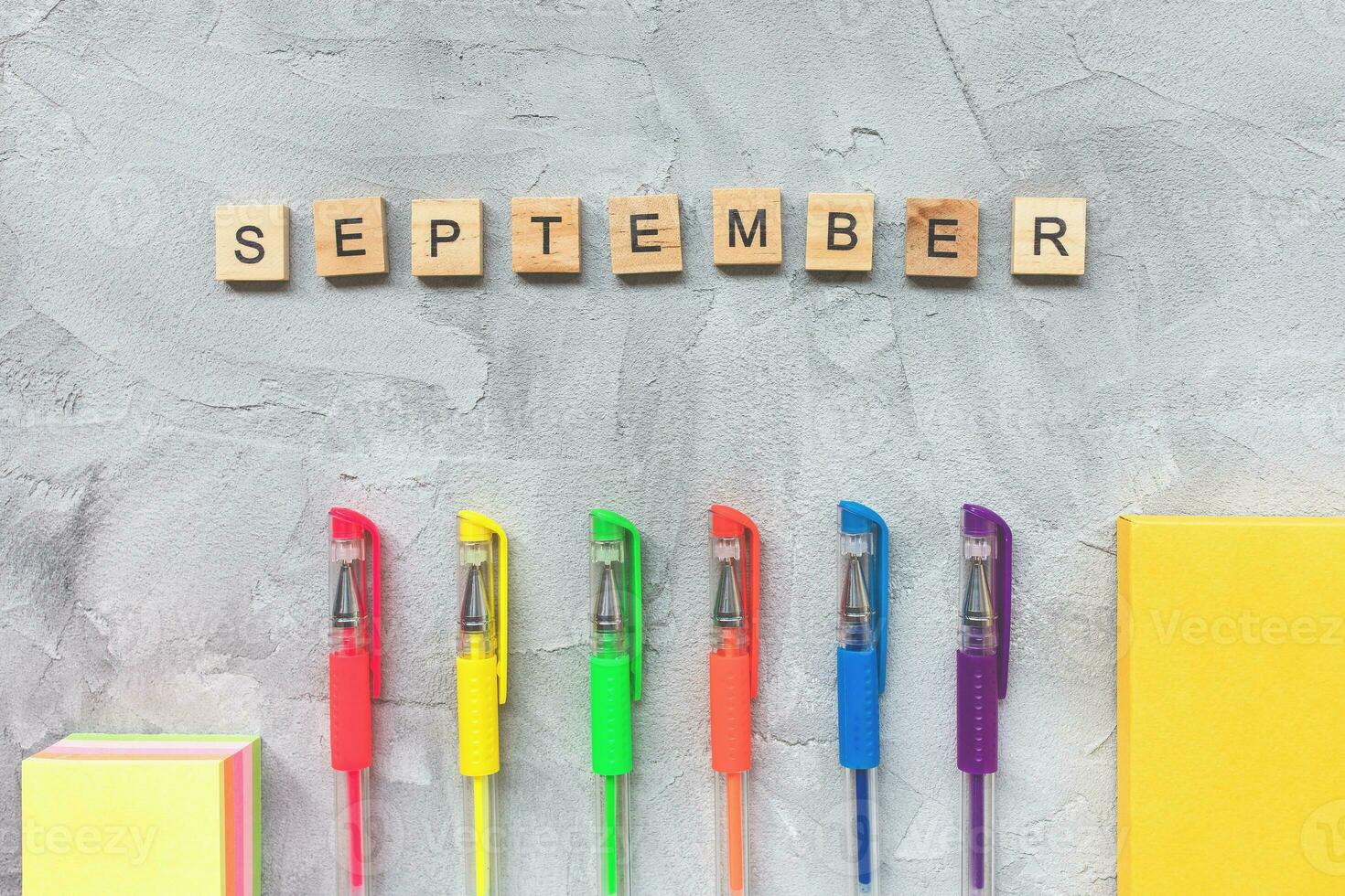 Word SEPTEMBER and multicolored gel pens photo