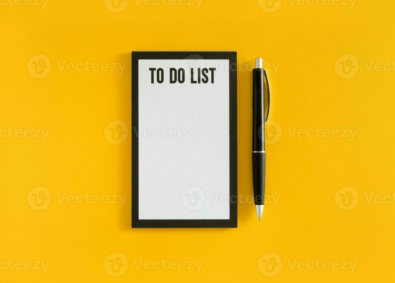 White sheet with to do list phrase and black pen on yellow background. Stock photo. photo