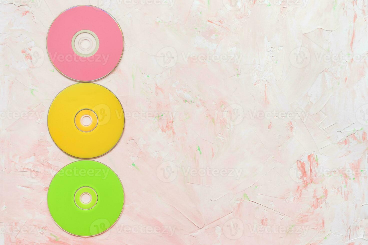 CD or DVD discs on pink background photo