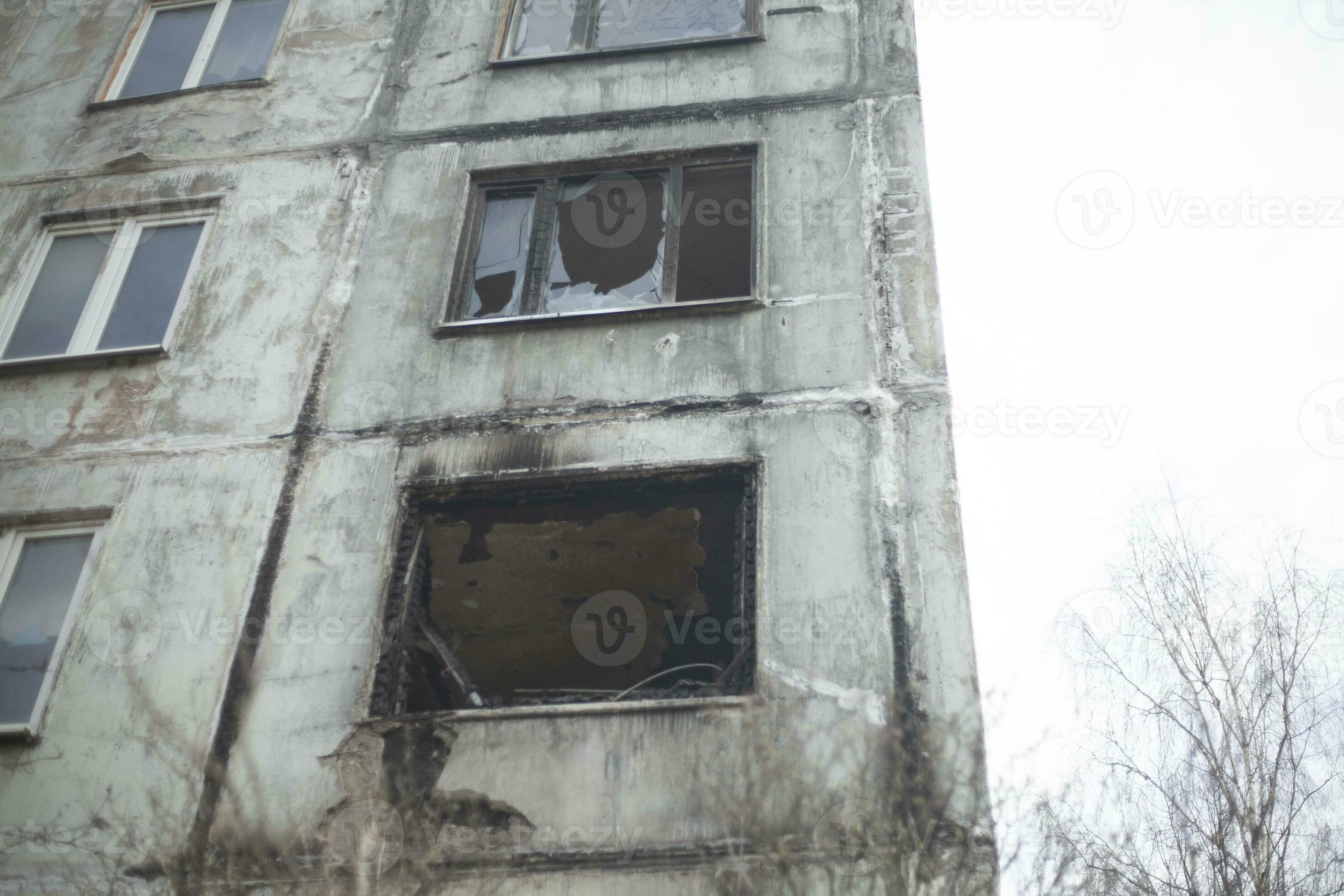 Burnt house. Apartment burned down in multistorey building. Fire in apartment. Broken window