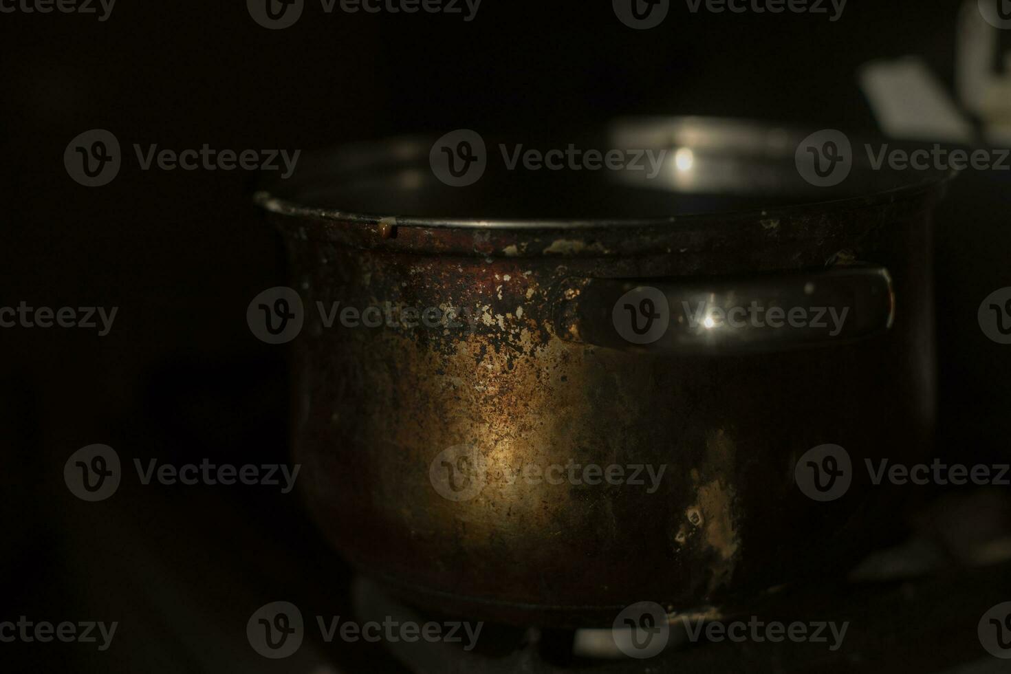 Old pot in morning in kitchen. Rusty pan. Kitchen details. photo