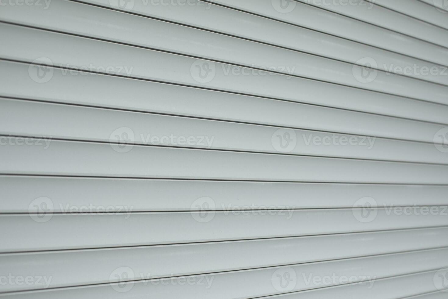 Blinds on window. Plastic shutters. Ribbed surface. photo