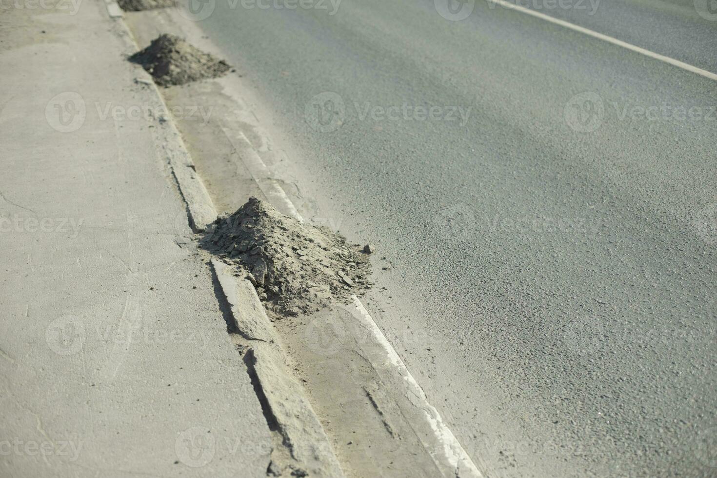 Dirt on road. Dust at curb. Asphalt cleaning. photo