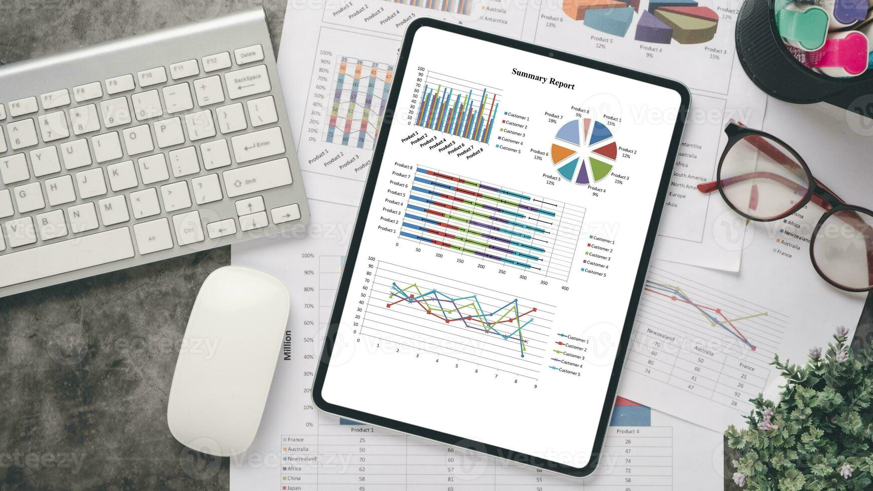 Tablet with charts and reports on office desk workplace. Top view flat lay. photo