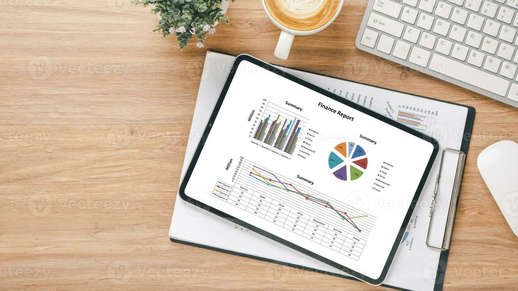 Tablet with charts and reports on office desk workplace. Top view flat lay photo