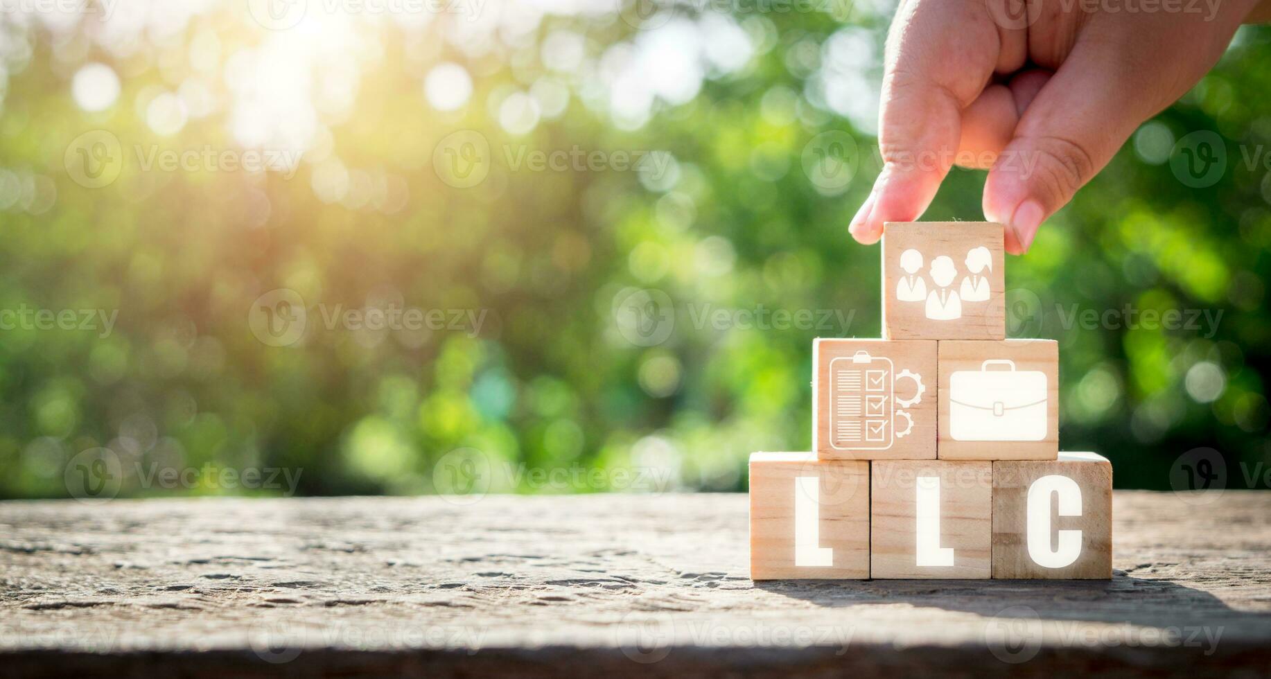 Limited Liability Company Business Concept, Person hand holding wooden block with limited liability company icon on virtual screen. photo