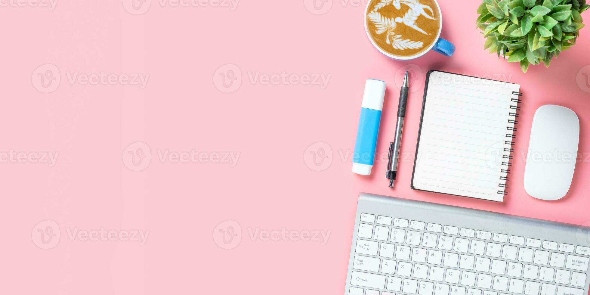 Top view, Pink Office desk with keyboard, Pen, notebook and Cup of coffee, copy space, Mock up.. photo