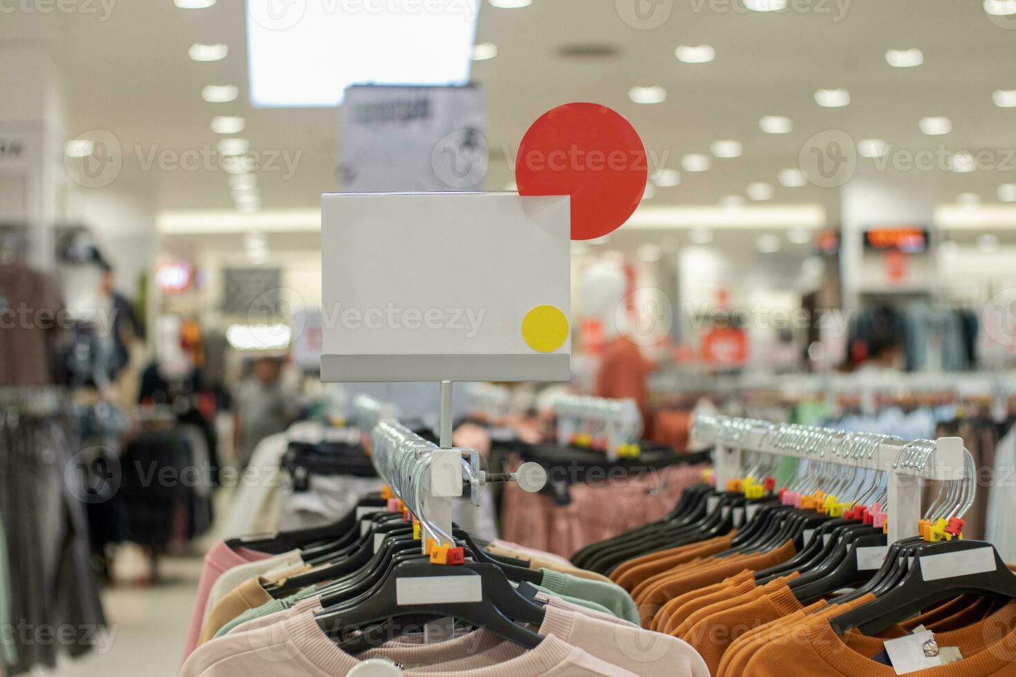 selective focus to blank white board for women's and men's clothing discount template in mall. soft focus photo